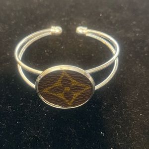 Leather symbol on silver bracelet